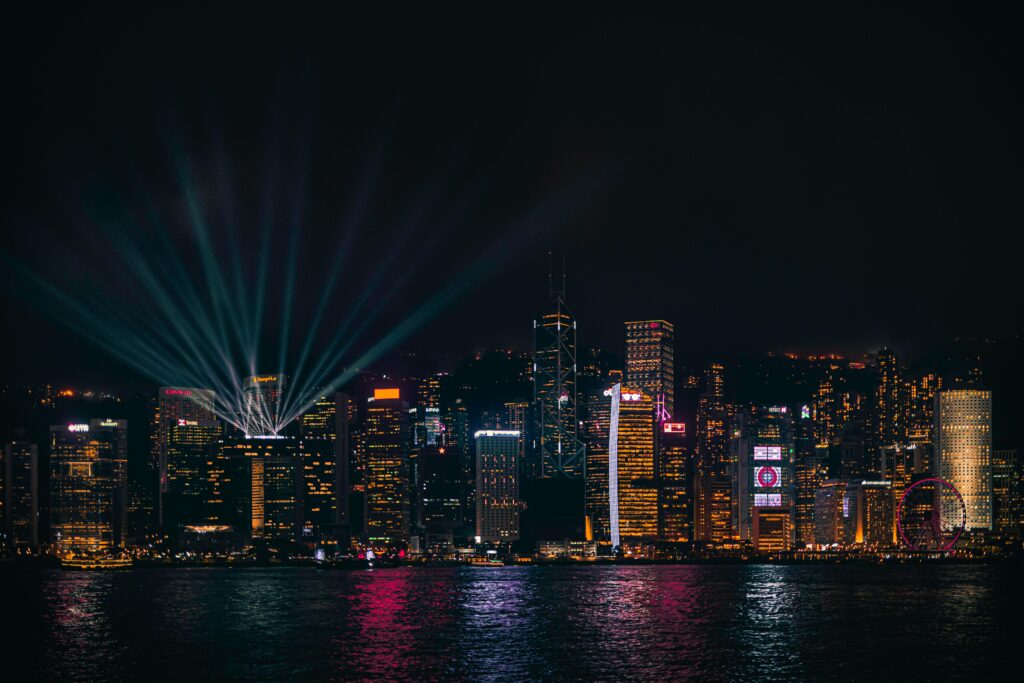 Stunning shot of Hong Kong's illuminated skyline at night, featuring skyscrapers and Victoria Harbour.